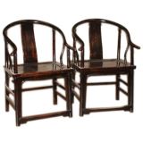 A Pair Of Black Lacquer Horseshoe Back Armchairs
