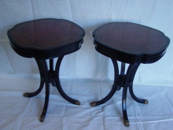 A Pair of Ebonized end tables with leather tops in a tortoise shell grain.Brass feet on very beautifully shaped legs.