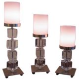 A set of three lucite and chrome lamps with wax shades.