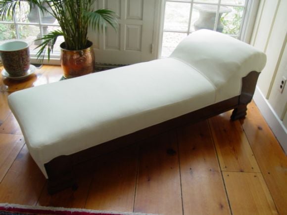 This very comfortable Empire Fainting Couch has an Oak Wood frame,with carved detailing on legs  and sides,covered in an ivory linen.