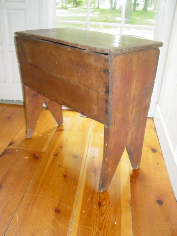 A charming old country piece with old red grain paint has lots of wear,the lid can be removed for storage ,could be used as a planter or table top.