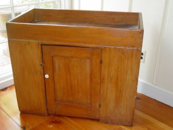 A charming New England Dry Sink,has one opening door with ceramic pull,origional brown/red milk paint finnish.