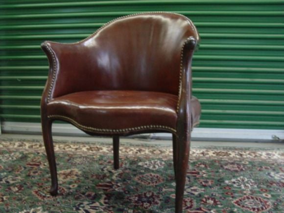 Striking Pair of 19thc English Leather barrel back chairs.Mahogany/walnut wood frames,soft brown leather,and antique nail heads.