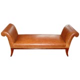 Classic scrolled armed leather bench.