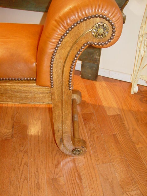 20th Century Leather Upholstered Light Mahogany Rolled Arm Bench.