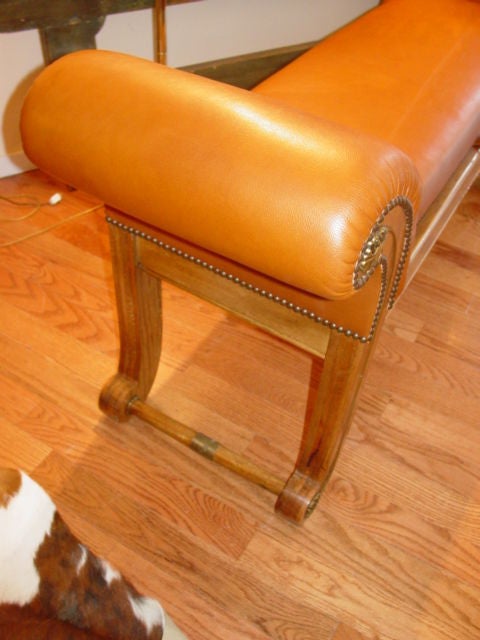 Leather upholstered light mahogany rolled arn bench with brass detail on volutes,seat lifts for storage.Fine soft Italian tan brown leather.
