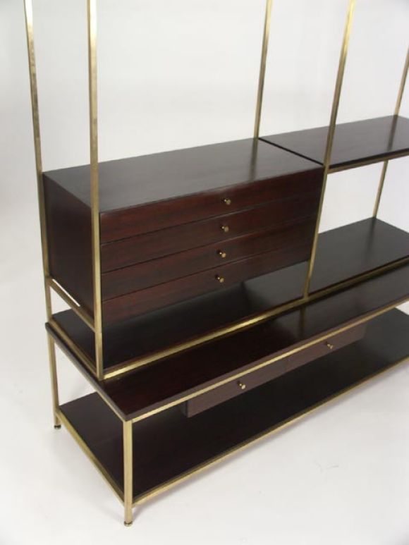 Excellent etagere by Paul McCobb. Mahogany surfaces and drawers encased in a solid brass frame. Two piece design, finishe don all sides for free standing use. Six small drawers the uppermost with metal signature tag.