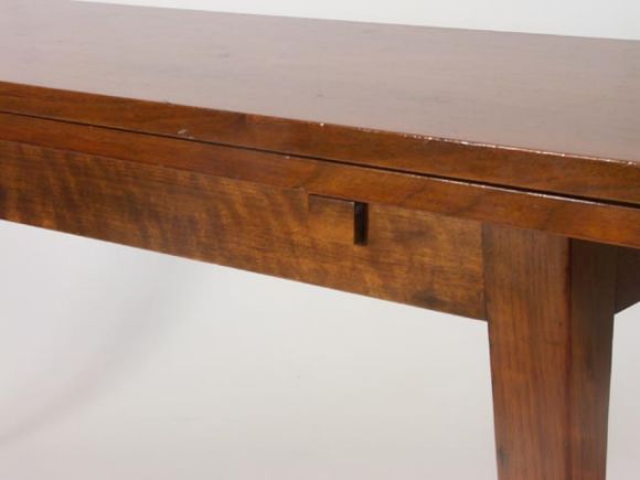 Simplistic masterpiece by Wormley for Dunbar. Slender walnut legs, and span support a doubled over top when closed. Opening like a book to create an excellent dining surface with matched top grain on each panel. 34