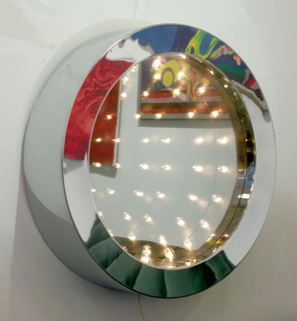 Brilliant futuristic art object/mirror by Curtis Jere. Deep chrome frame houses a double pane mirror with a series of lights, reflected into infinity. Very sleek design, typical of Jere. Signed on the frame.