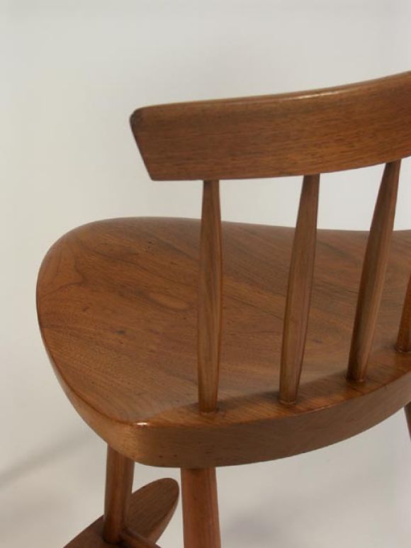 Two pairs of Mira stools by Nakashima. The early pair in black walnut with hand cut back rails. The later pair in a lighter walnut. Each is a wonderful low perch stool with footrest. PRICED INDIVIDUALLY.