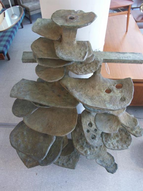 Pictures can only begin to do justice to this incredible creation. Executed in solid bronze by Edgar Britton, Denver Colorado 1957. An incredibly organic form, composed of lily-pad like petals, increasing in size as they descend. The entire surface