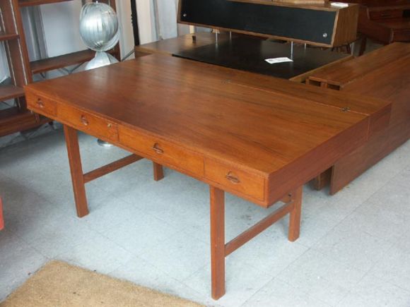 Excellent teak desk with flip down secretary section. Sold in the US thru George Jensen shops, manufactured by Lovig, the design being attributed to Jens Quistgaard. Includes original keys.