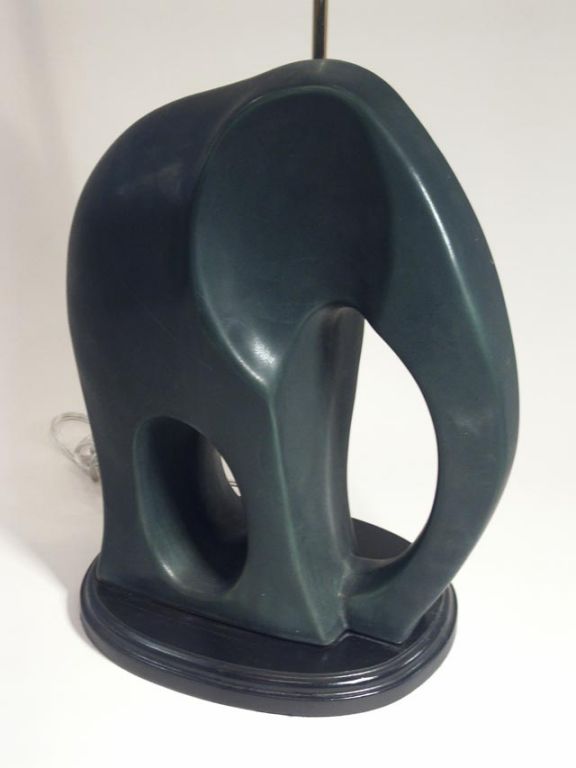 Modeled after a famous art deco sculpture by Ferdinand Parpan, these wonderful ceramic elephants are mounted as table lamps. Each an abstract of the true king of the jungle, with a dark flat ebony glaze finish. New electric fittings. Priced as a