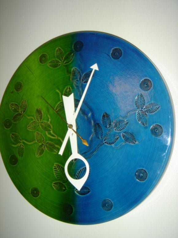 Ceramic clock manufactured by Howard Miller. Beautiful green and blue glaze with incised leaves. Electric motor, all original. Ceramic signed Italy.