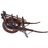 Antique elmwood wheelbarrow and people cart