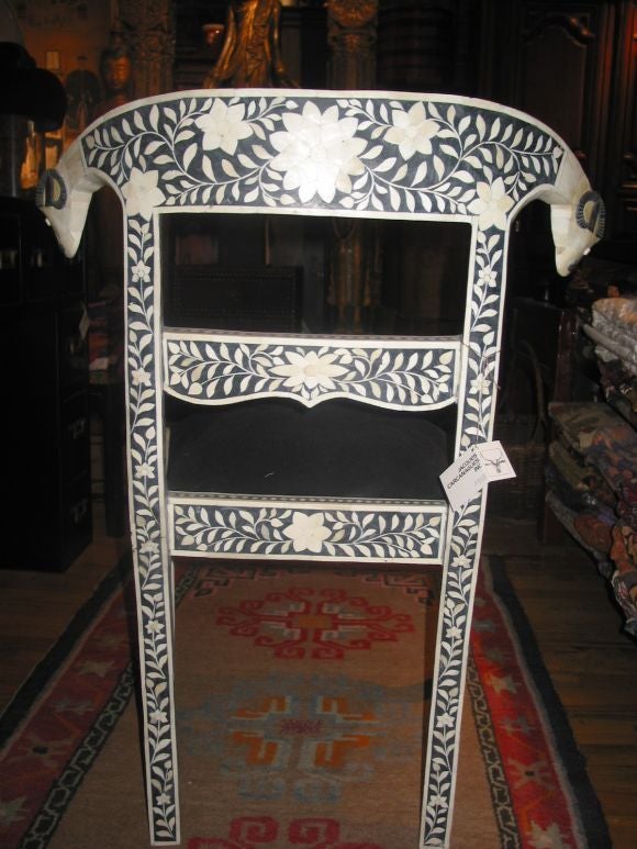Beautifully ornate white water-buffalo horn inlaid on black teak, in floral designs.