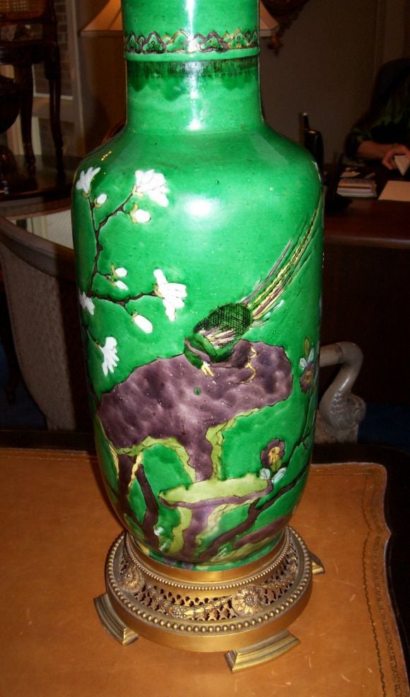 Now Gilt Bronze Mounted as a Lamp<br />
Of baluster form, decorated with prunus branches and a peacock on an emerald green ground.  Fitted on a beaded and trellis pierced gilt bronze base mounted with cast rosettes and berried swags, surmounted by