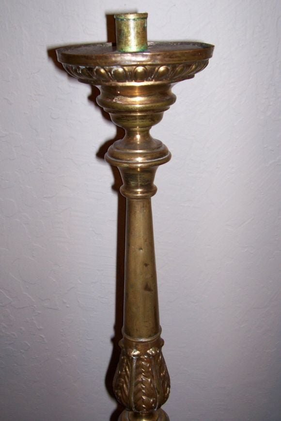 Now Mounted as Candlesticks<br />
Each acanthus cast and tapering standard surmounted by a gadrooned outswept candle platform with later candle holder, above a tripartite base, each side cast with a scroll bracketed cartouche and trelliswork