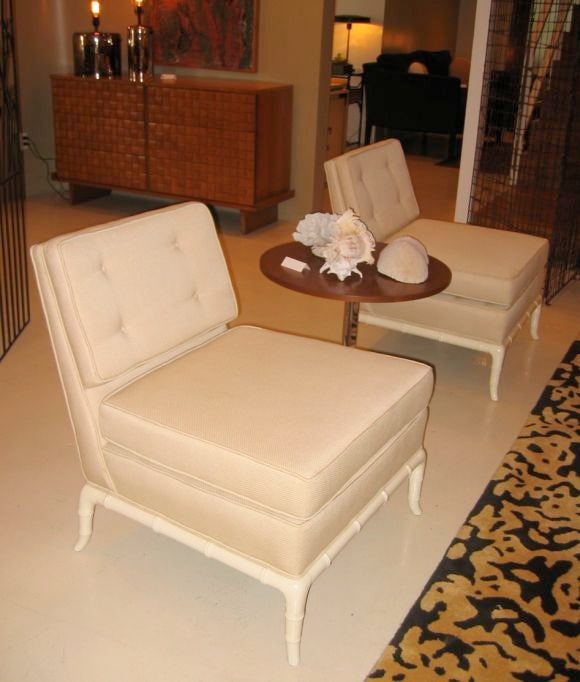 Pair of gorgeous slipper chairs with new cream upholstery and faux-bamboo cream lacquered base.  Atributed to TH Robsjohn-Gibbings for Widdicomb.