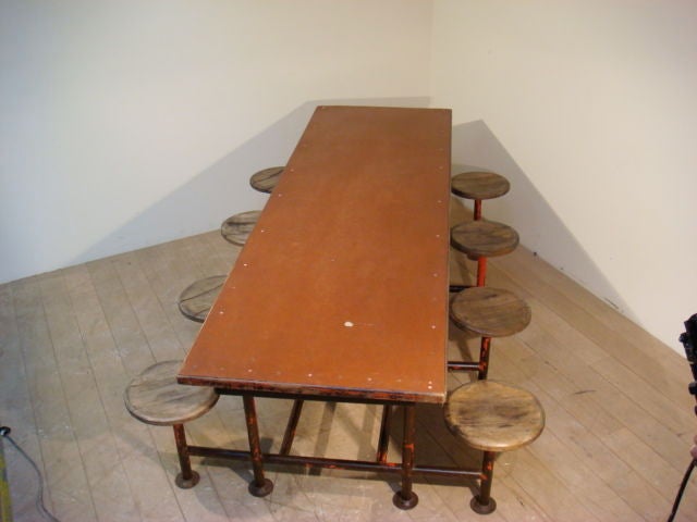 Red Iron Table With Eight Attached Stools