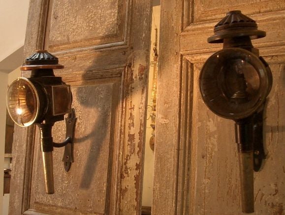 Pair of  19th century coach or carriage lanterns. One lantern showing signs of copper base metal, see photo #8 . Attractive patina and good quality 20th century iron brackets. Lanterns indicate previous wiring, but are not currently electrified.<br