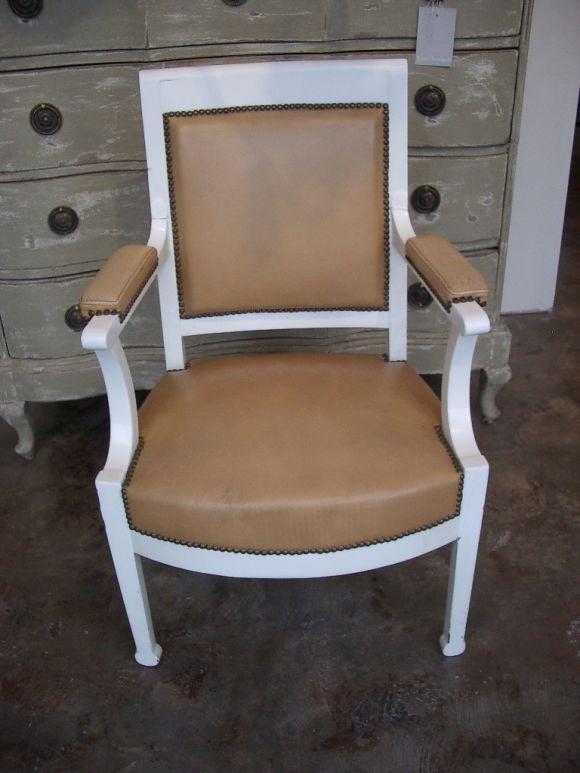 Pair of white lacquered chairs with nailheads and leather seats and back.