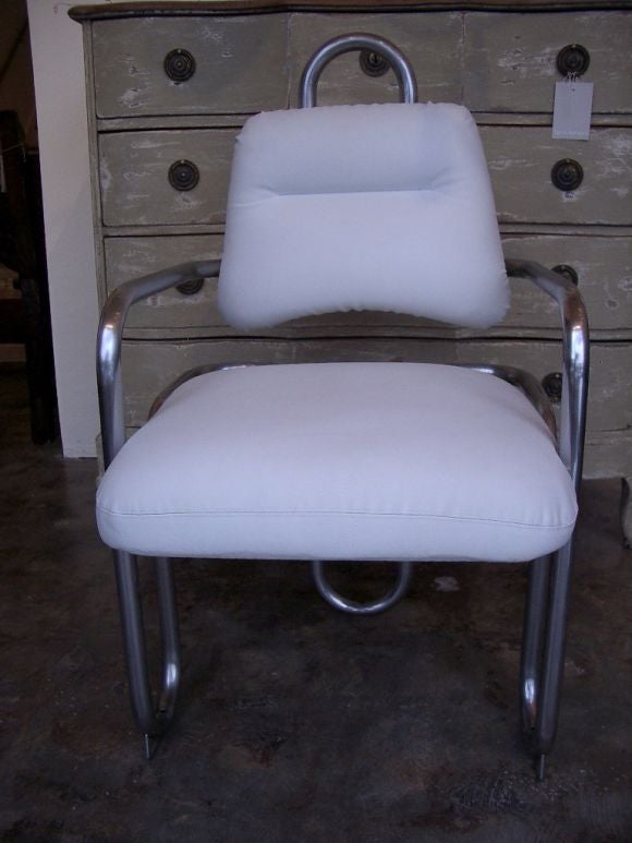 A pair of bent metal tube chairs by Kwok Hoi Chan newly upholstered in white leather.<br />
Please note that this item is located in our warehouse. Please call if you would like to see it in person.