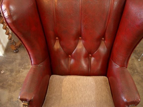 pair of faux red leather wingback chairs with new alpaca cushions.