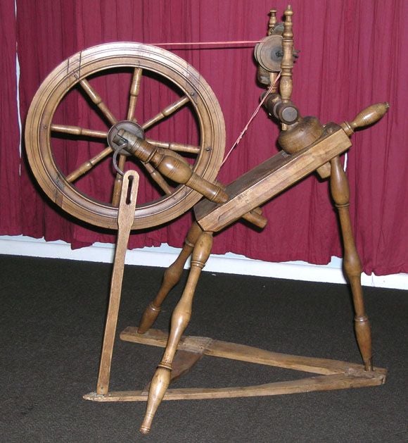 Antique spinning wheel made of birch. In working order, a decorative accent piece.
