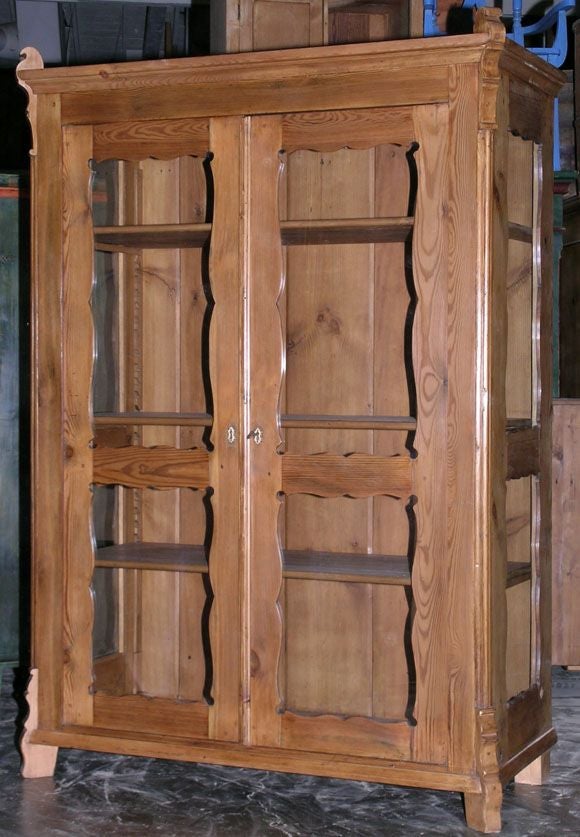 Display cabinet with eight glass panels. The interior shelving is adjustable. Original lock still works, keyhole adorned with carved horn escutcheons. A beautiful and versatile piece of furniture. More photos available by request.