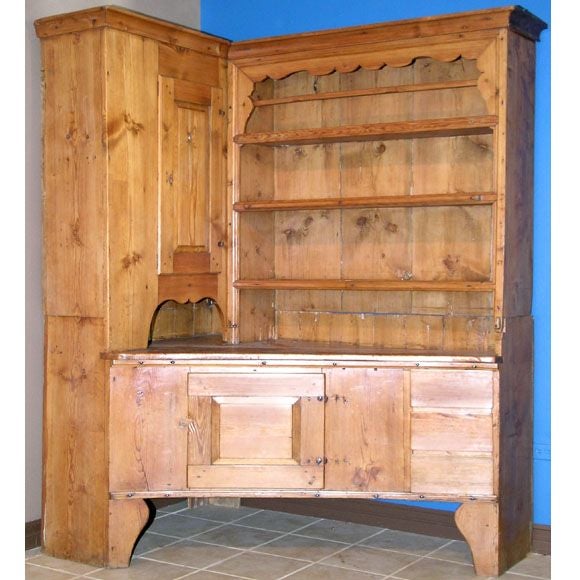 Corner hutch from Northern Sweden. This is a massive piece of furniture, luckily it comes apart in three sections. The bottom cabinet has a curved, concave front with a door and three drawers. The upper cabinet and plate rack can be moved separately.