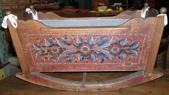 Baby cradle from the Swedish province of Dalarna. The rosemaling is original and typical of this region. The paint is in excellent condition on both sides but is all but worn off on the ends.