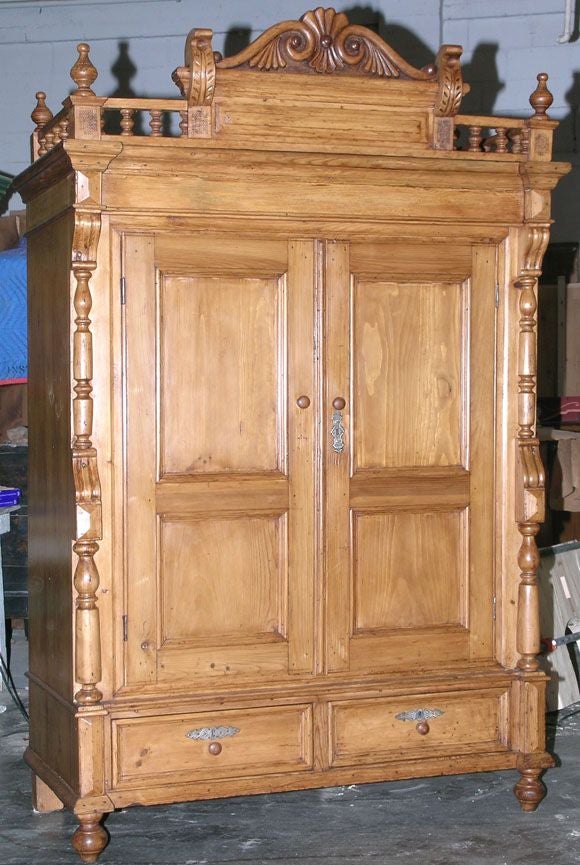 This beautiful armoire with a Gothic flair was made in Russia in the 1870s. The two spacious drawers below afford extra storage. This cabinet was constructed entirely with dove-tail and mortise and tenon joints, no nails or screws! The back and