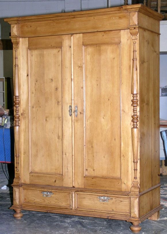 This beautiful armoire was made in Russia in the 1880's. The two spacious drawers below afford extra storage. This cabinet was constructed entirely with dove-tail and mortise & tenon joints, no nails or screws! The back and doors were made with
