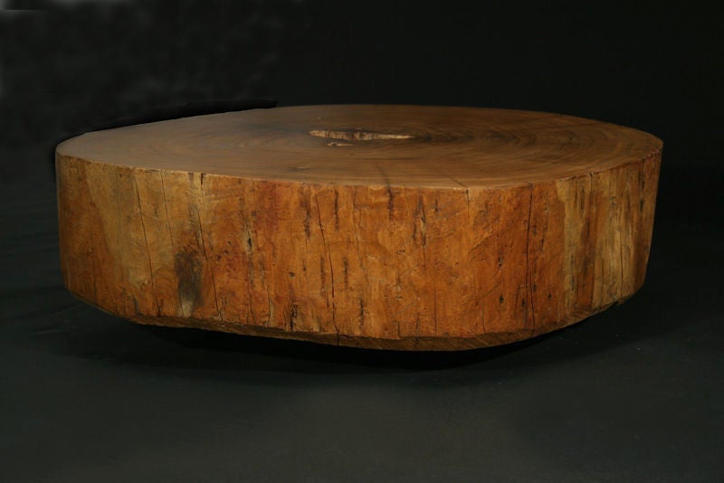 This table was made from the reclaimed trunk of a peroba wood tree from Brazil.  The top has been finished and polished and the sides show the raw origins of the original tree.  Three solid bronze legs have been fashioned to support this low