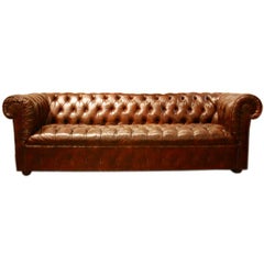 Brown leather chesterfield sofa with bronze tacks