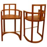 Pair of banded teak barstools with brass foot runner