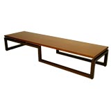Long low coffee table in walnut and mahogany by Baker
