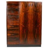 Tall rosewood dresser with black pulls by Harvey Probber