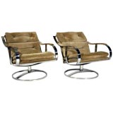 Pair of curved arm chrome and suede swivel lounge chairs