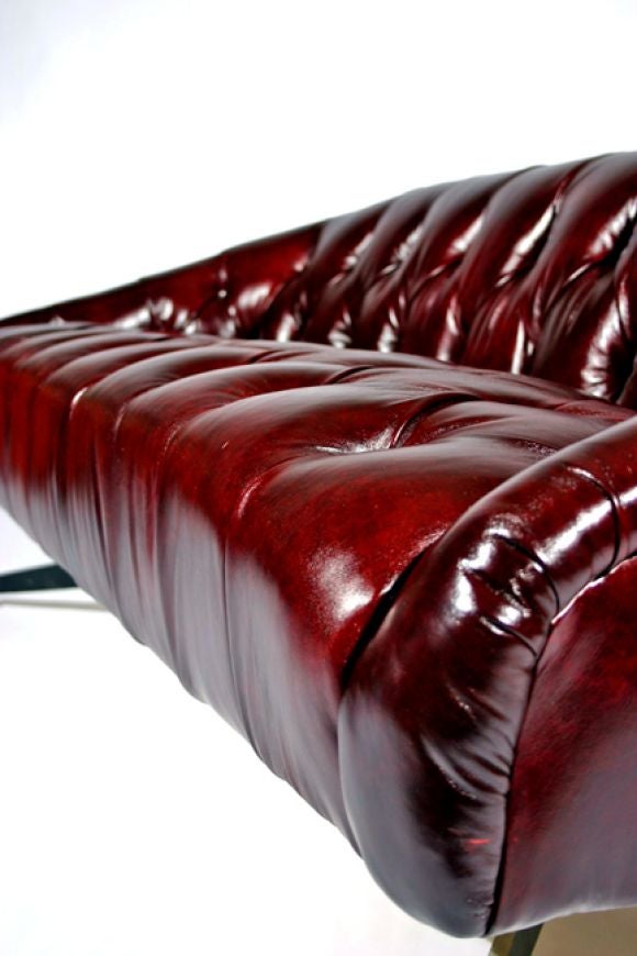 Leather Tufted leather sofa with steel base by Ward Bennett