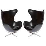 Pair of Arne Jacobsen black leather egg chairs