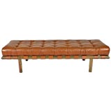 Patinated bronze base and leather tufted bench