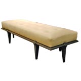 Leather bench with sculpted walnut base by Paul Laszlo