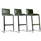 Set of three leather and flat bar chromed steel bar stools