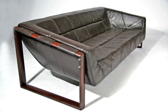 Leather sling style sofa with chrome hardware and mahogany sides.<br />
<br />
Seat Depth: 20