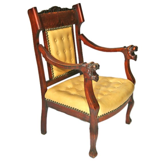 Antique lion's head leather and wooden arm chair