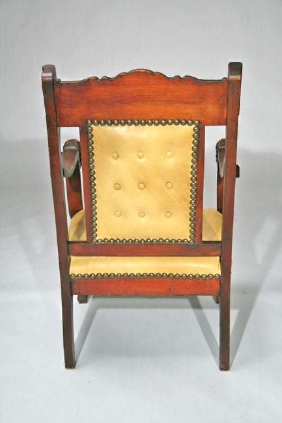 old wooden chair with lion head arms