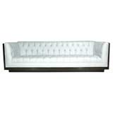 Tufted white leather sofa with walnut case by Milo Baughman
