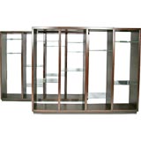 Pair of tall mahogany shelves by Dunbar with leather bases